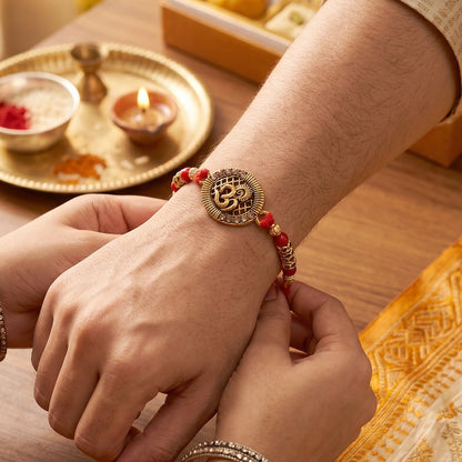 Antique Om Coin Rakhi with Rudraksha Beads and Red Thread