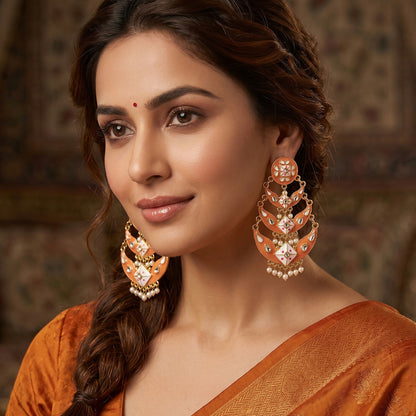Side angle of peach gold meenakari drop earring highlighting layered crescent design