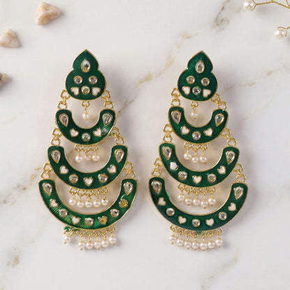 Side view of green layered chandbali earrings with pearl drops