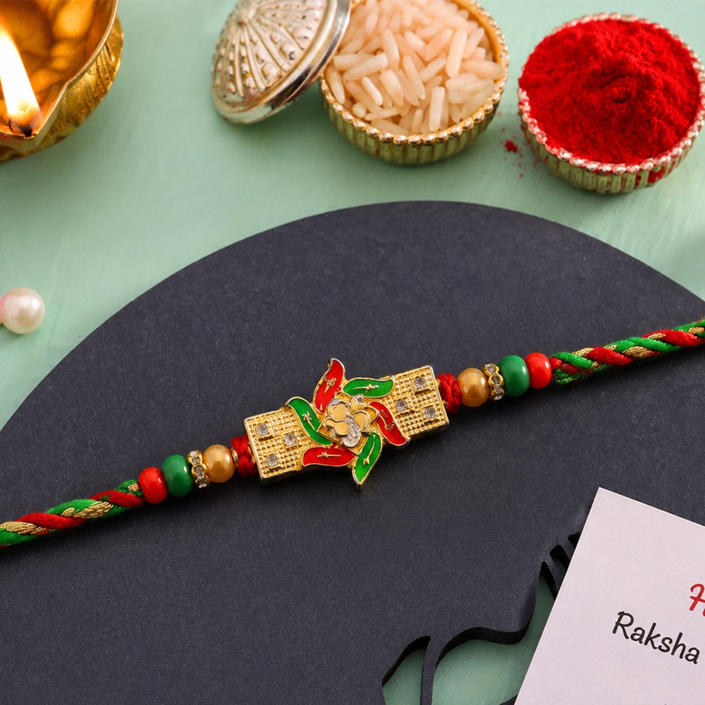 Festive Red & Green Meenakari Pinwheel AD Stone Rakhi for Brother Gift