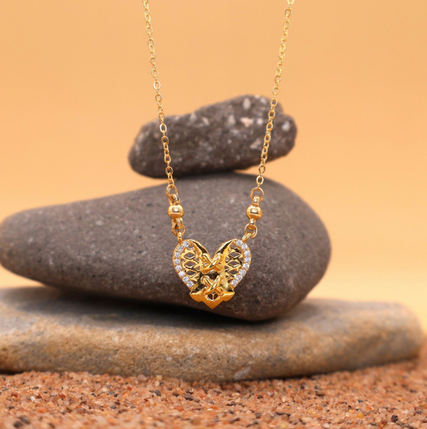 Diamond accented gold pendant necklace worn on a model