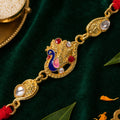 Elegant Rakhi showcasing Peacock Charm, color stones and gift style for Gift Styling