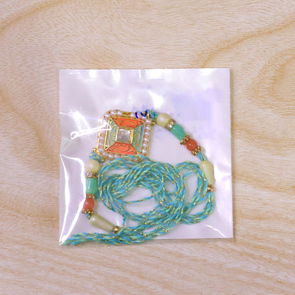 Pearl Bordered Meenakari Pendant Rakhi with Orange and Teal Enamel