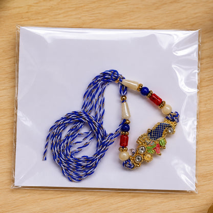 Peacock Motif Rakhi with Red Blue Beads and Elegant Traditional Gift Presentation