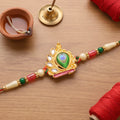 Peacock Feather Crown Kundan Pendant Rakhi with Pearl Beads