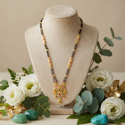 Colorful enamel base with pink petals and teal green accents on mangalsutra pendant