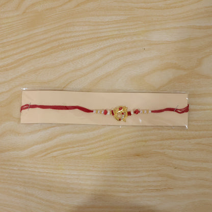 Golden Om Rakhi with Red Beads and Pearl Dotted Thread