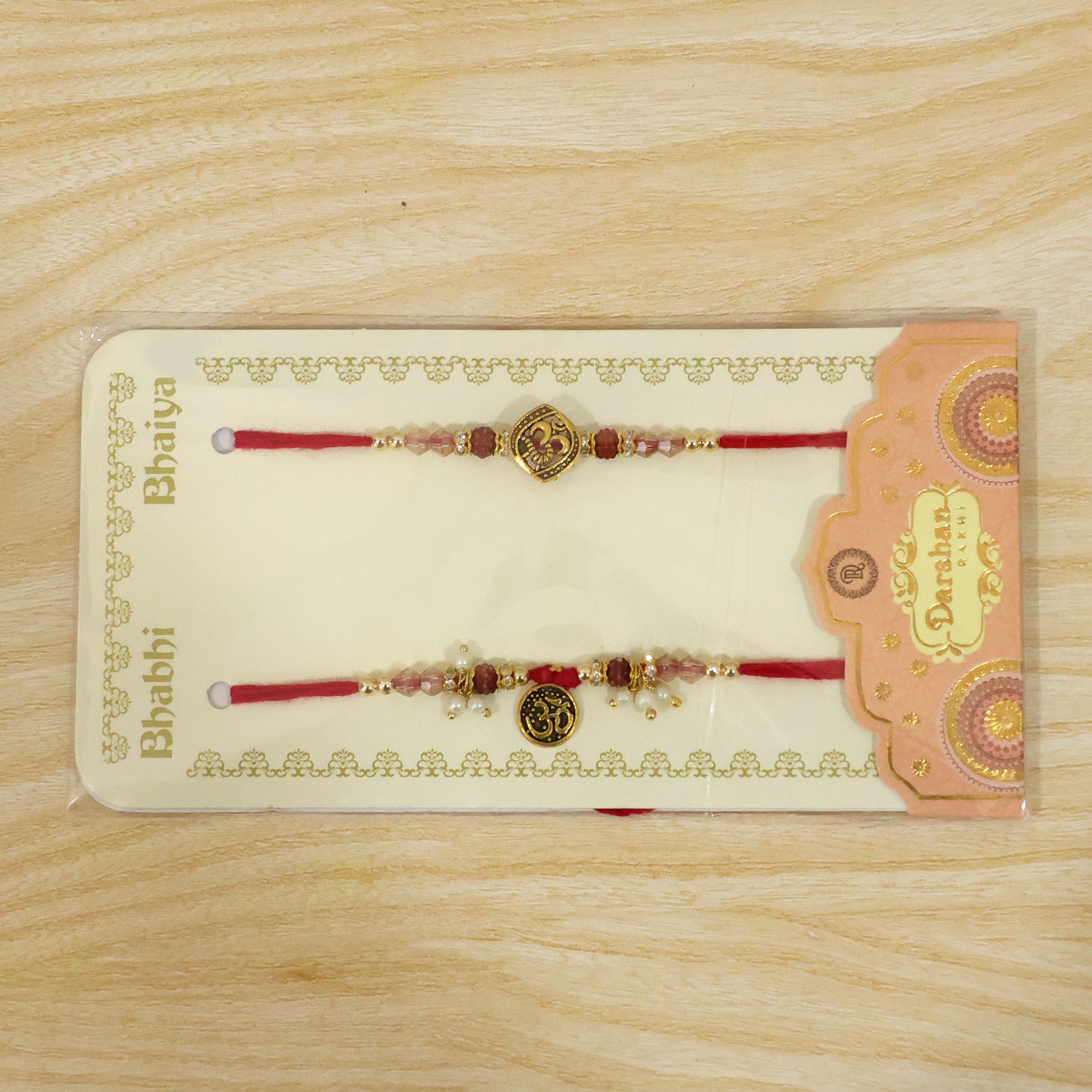 Graceful OM Symbol Bhai Bhabhi Rakhi with OM Medallion and Pearl Tassel for Gifting