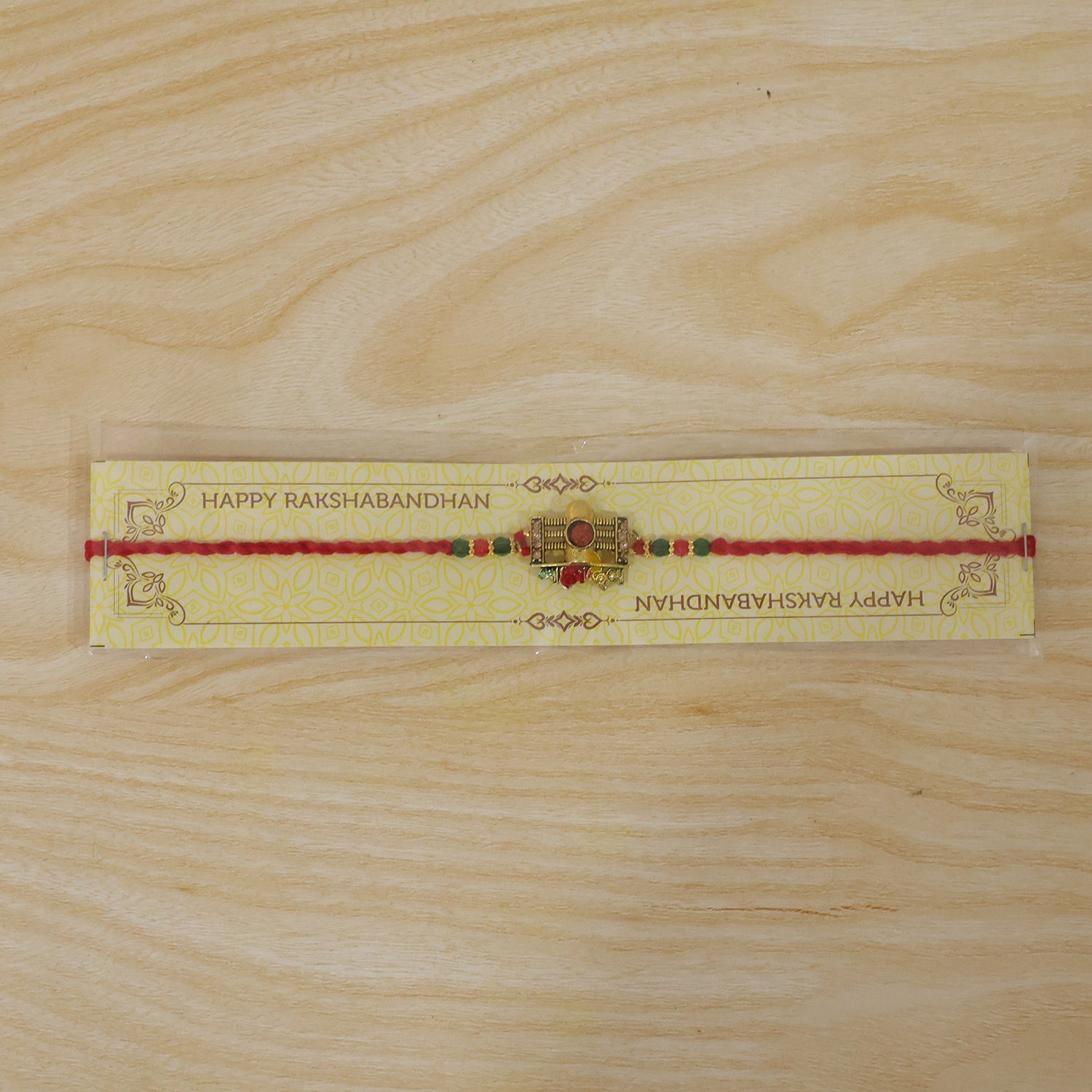 Traditional Shivling Rudraksha Rakhi with Red & Green Beads