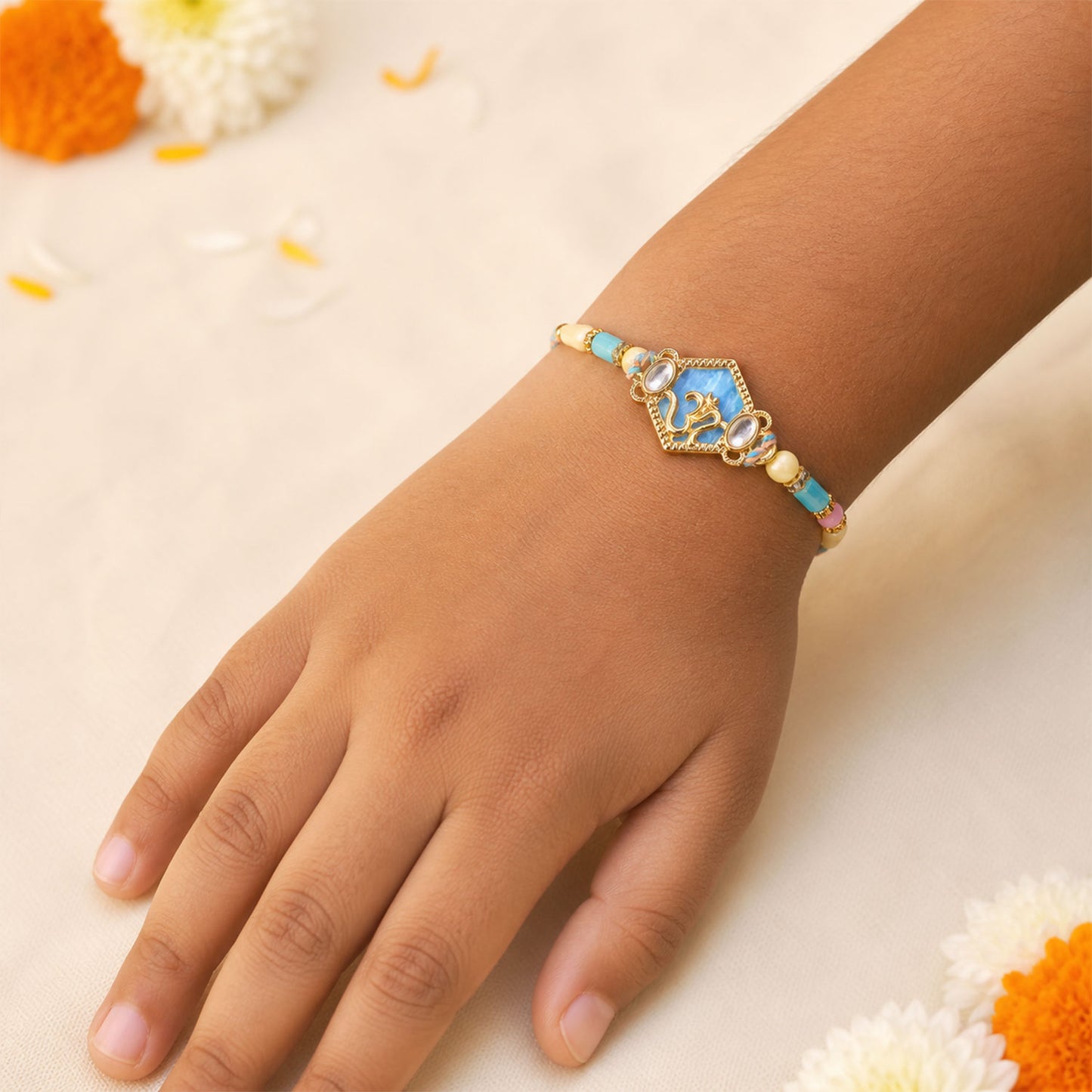 Om Hexagon Pendant Rakhi with Blue Enamel and Kundan Stones