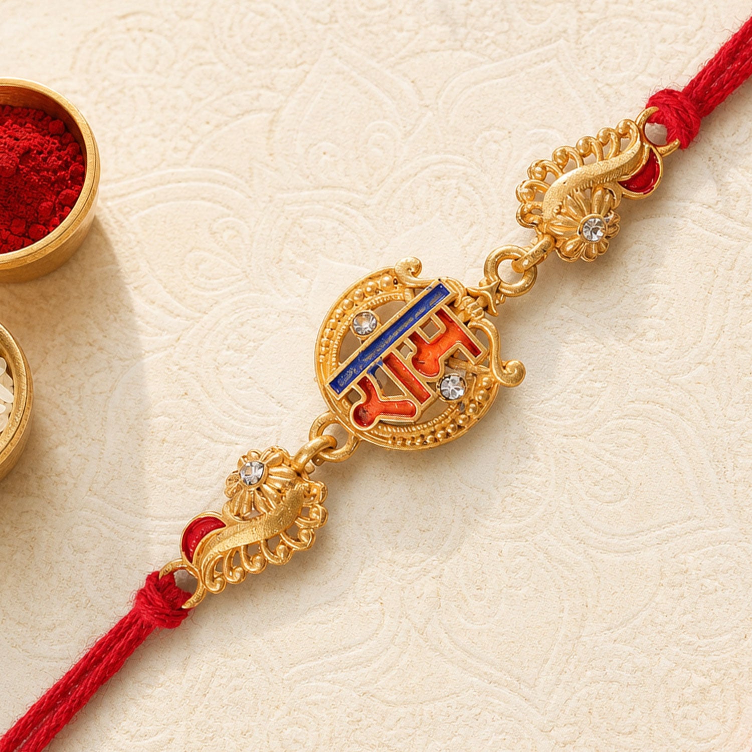 Gold-Toned Ram Rakhi with Orange-Blue Enamel, Crystal Accents & Red Thread