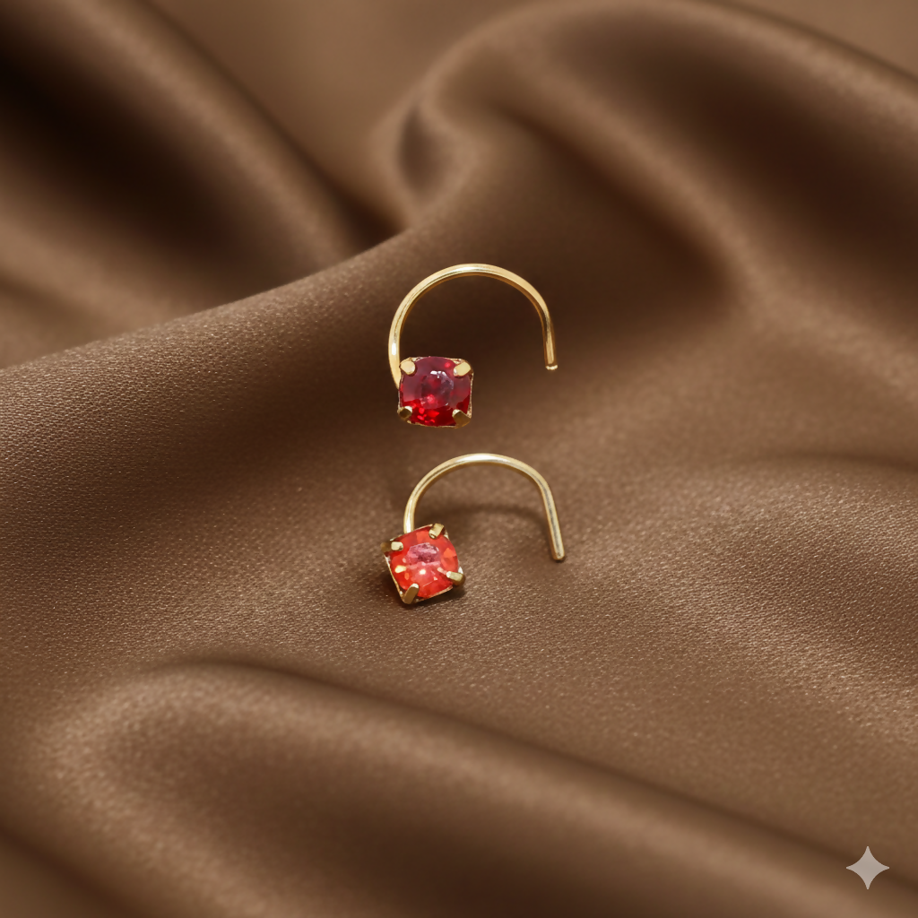 Red ruby crystal nosepin set with gold plating, displayed on a white background.