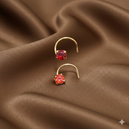 Red ruby crystal nosepin set with gold plating, displayed on a white background.