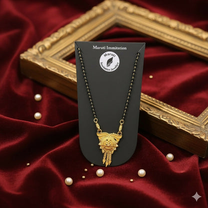 This stunning pendant, made of durable imitation metal and finished in gold tone, features detailed craftsmanship and a regal tassel drop.