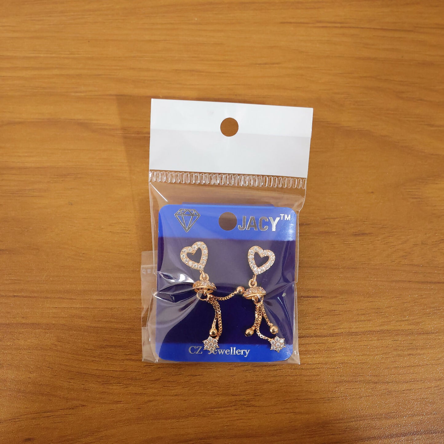 Rose gold romantic dangle earrings displaying fine dome accent and tassel tips