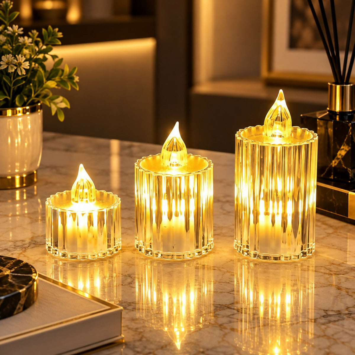 Three glowing crystal-look LED candles on a marble surface with a plant and diffuser in the background.