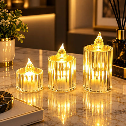 Three glowing crystal-look LED candles on a marble surface with a plant and diffuser in the background.