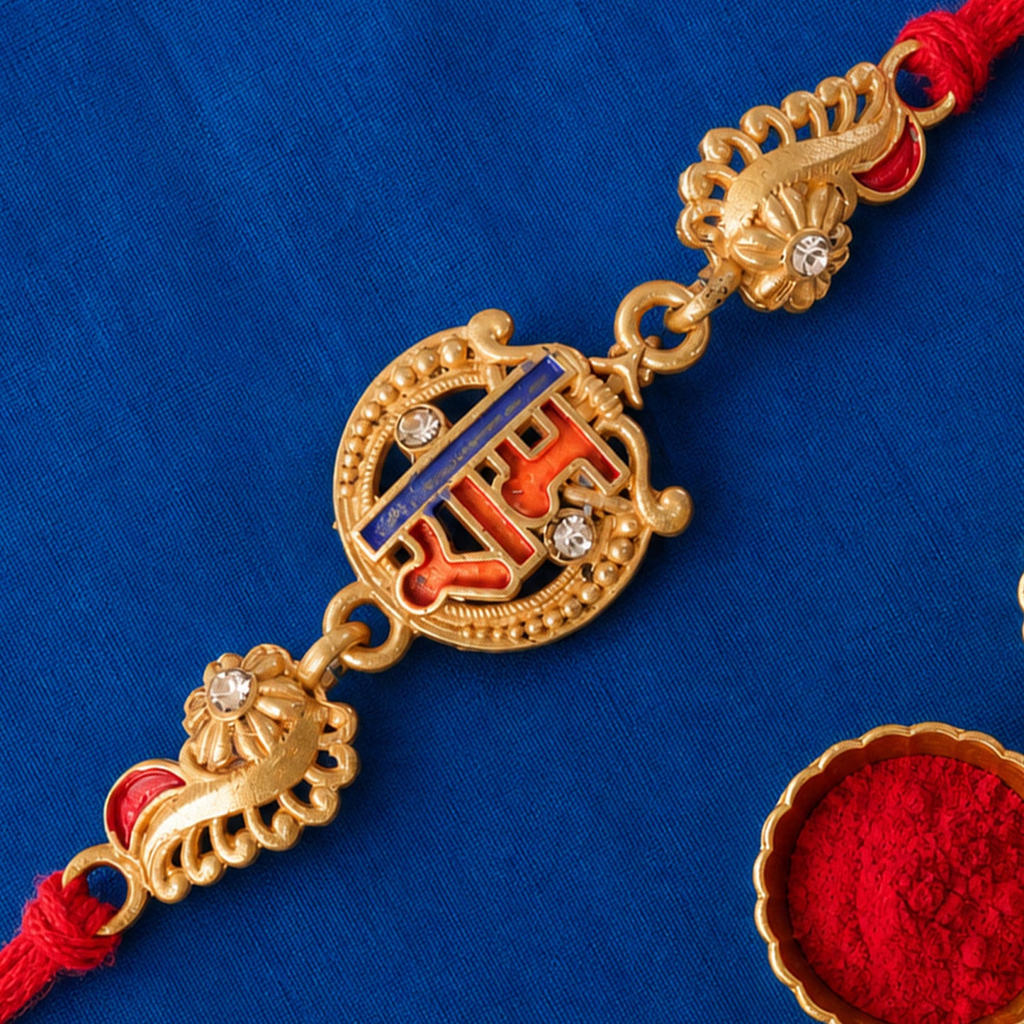 Gold-Toned Ram Rakhi with Orange-Blue Enamel, Crystal Accents & Red Thread