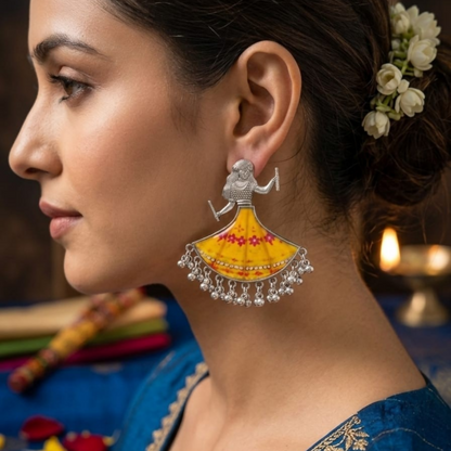 A woman models a single Dandiya girl earring, showcasing its size and how it hangs from the earlobe.