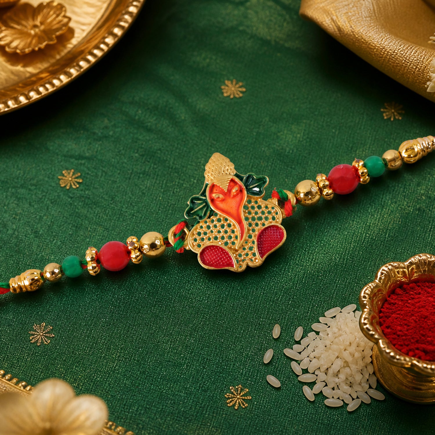 Gold Ganesha Pendant Rakhi with Red and Green Enamel