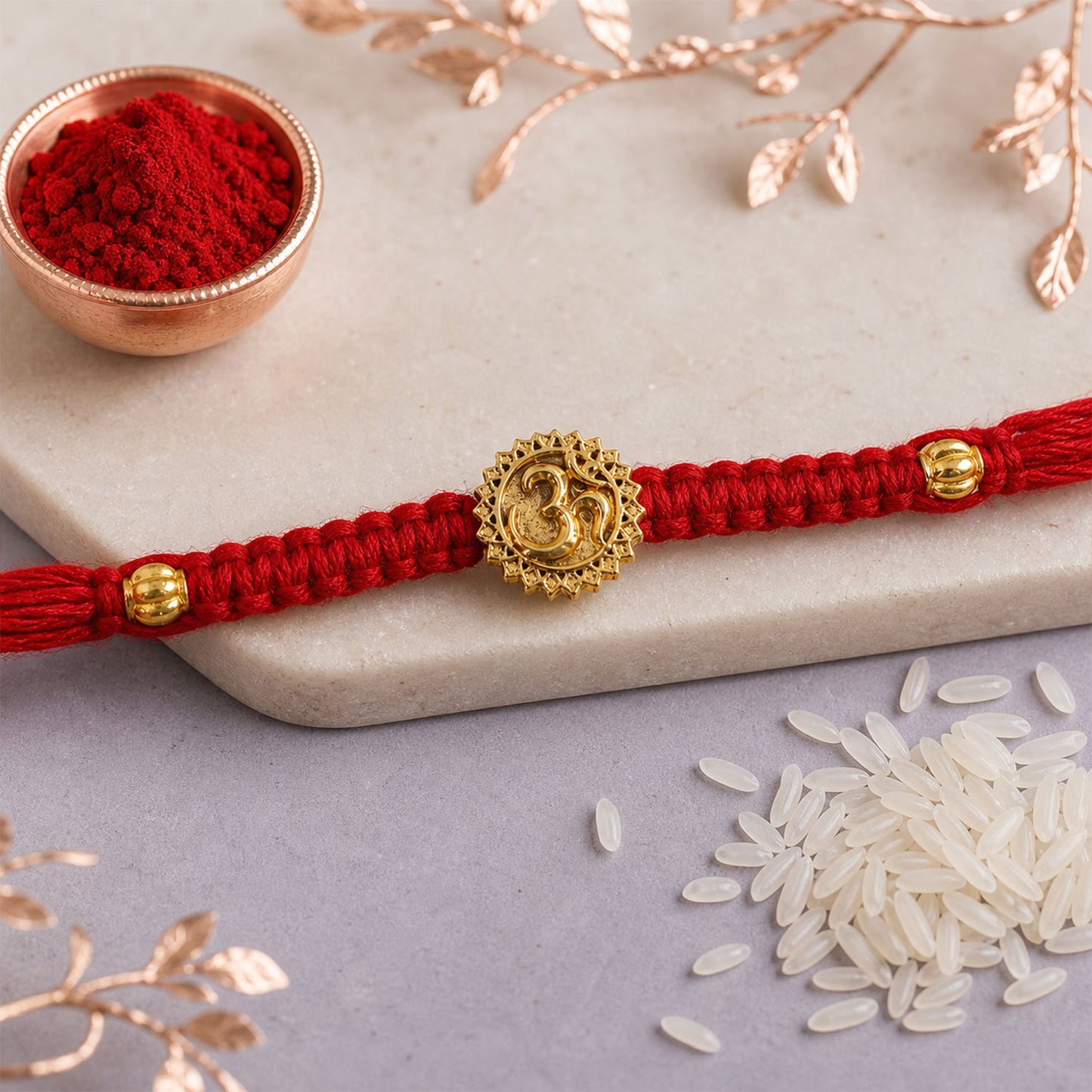 Red Thread Rakhi with an Antique Gold Om Pendant and Beaded Accents