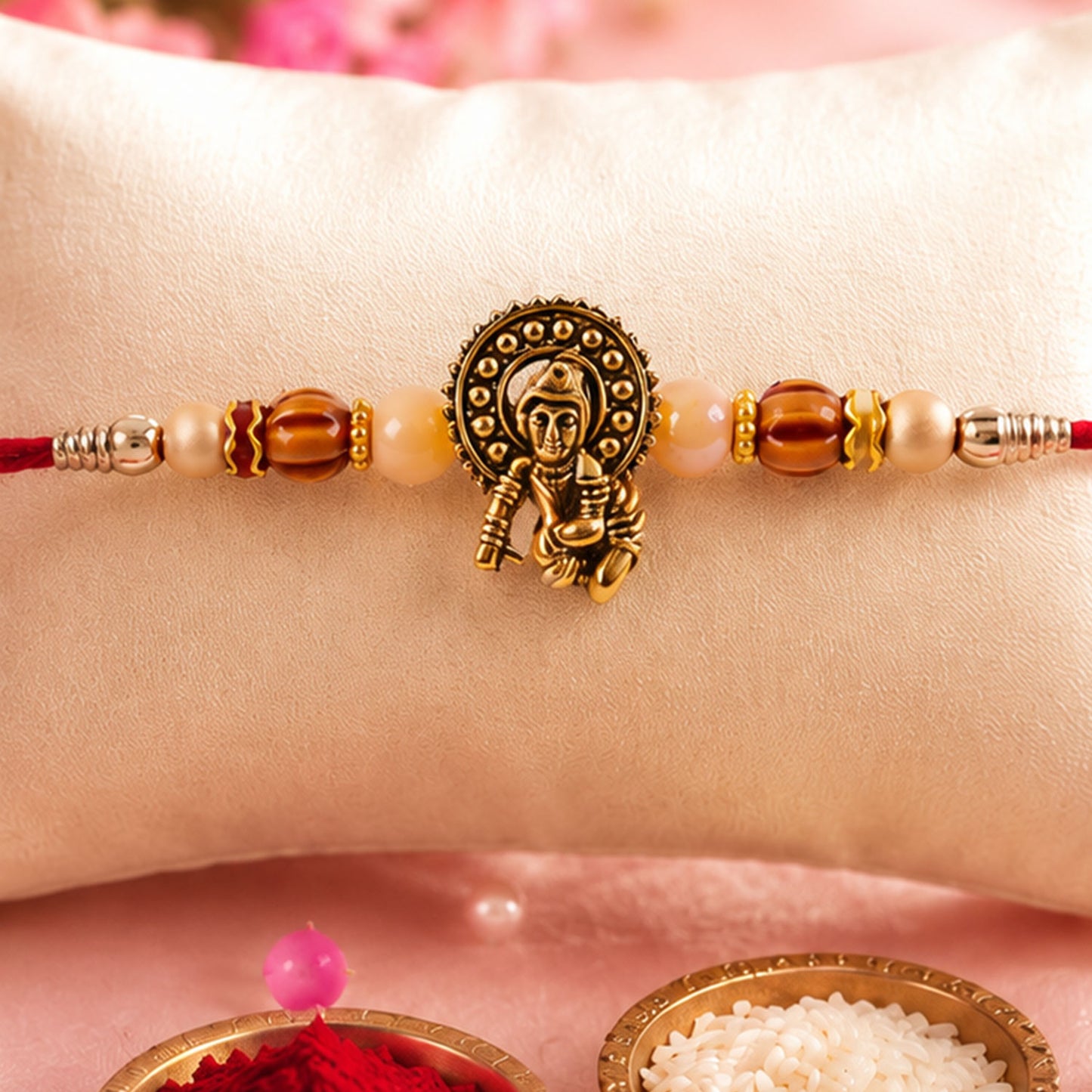 Antique Deity Idol Devotional Rakhi with Golden Medallion, Peach Beads and Red Thread