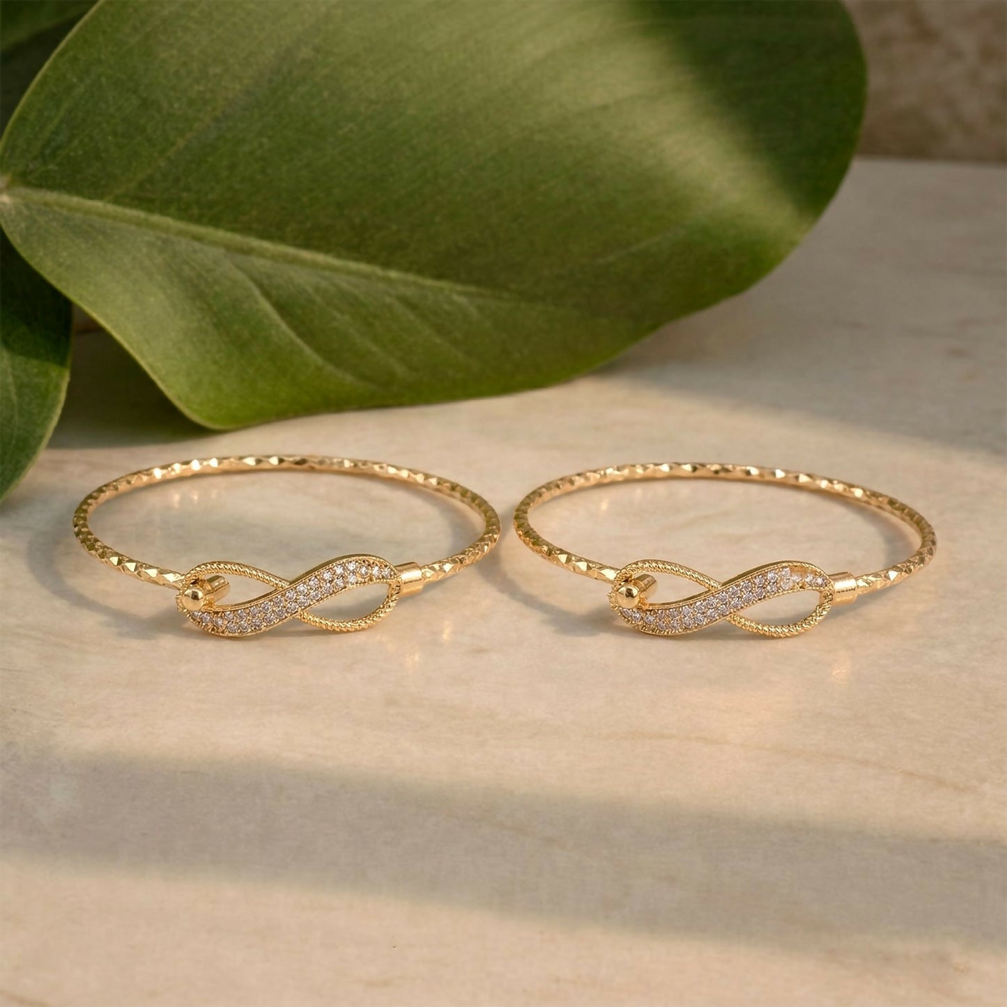 Close-up view of sparkling stones on gold infinity bracelet