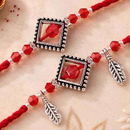Red Gem Square Rakhi Set with Silver Bead Border and Leaf Charms for Couple Gift