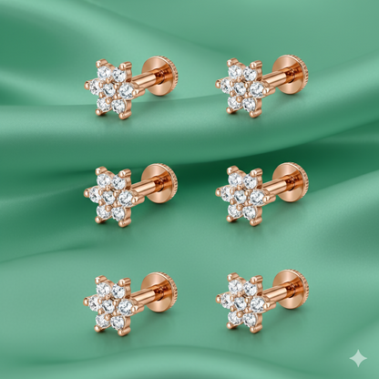 Close-up view of rose gold flower stud earrings showcasing intricate floral design