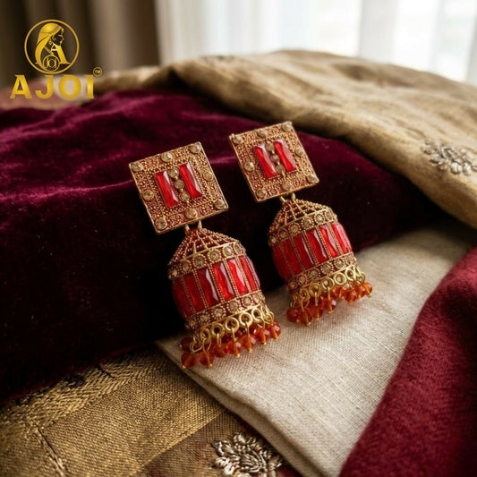Close-up of Royal Red Temple Earrings showing red stone inlay and gold beaded textures