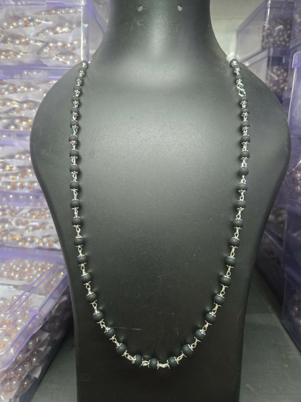 Kalungi Mala worn showcasing matte black beads and silver spacers as a spiritual necklace