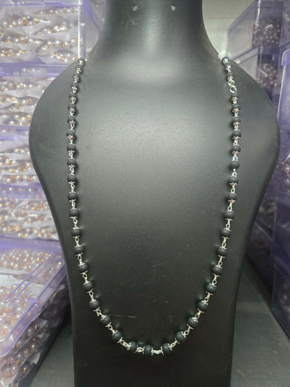 Kalungi Mala worn showcasing matte black beads and silver spacers as a spiritual necklace