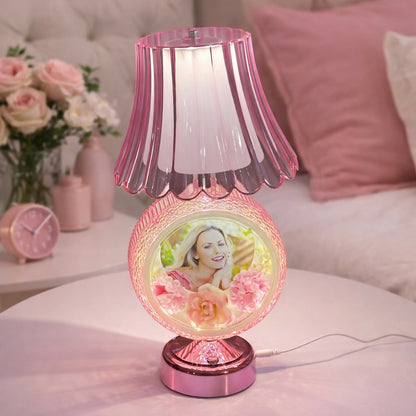 Round photo table lamp with decorative shade on wooden table