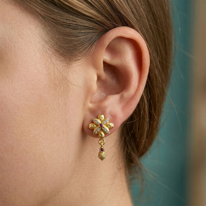Close-up of beautifully crafted gold plated floral drop earrings.