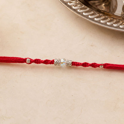 Red Braided Rakhi with a Row of Sparkling Crystal Bead Accents