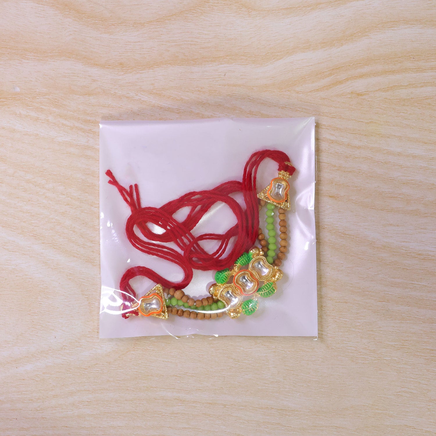 Traditional Triple Kundan & Green Leaf Motif Rakhi with Wooden & Green Beaded Strand
