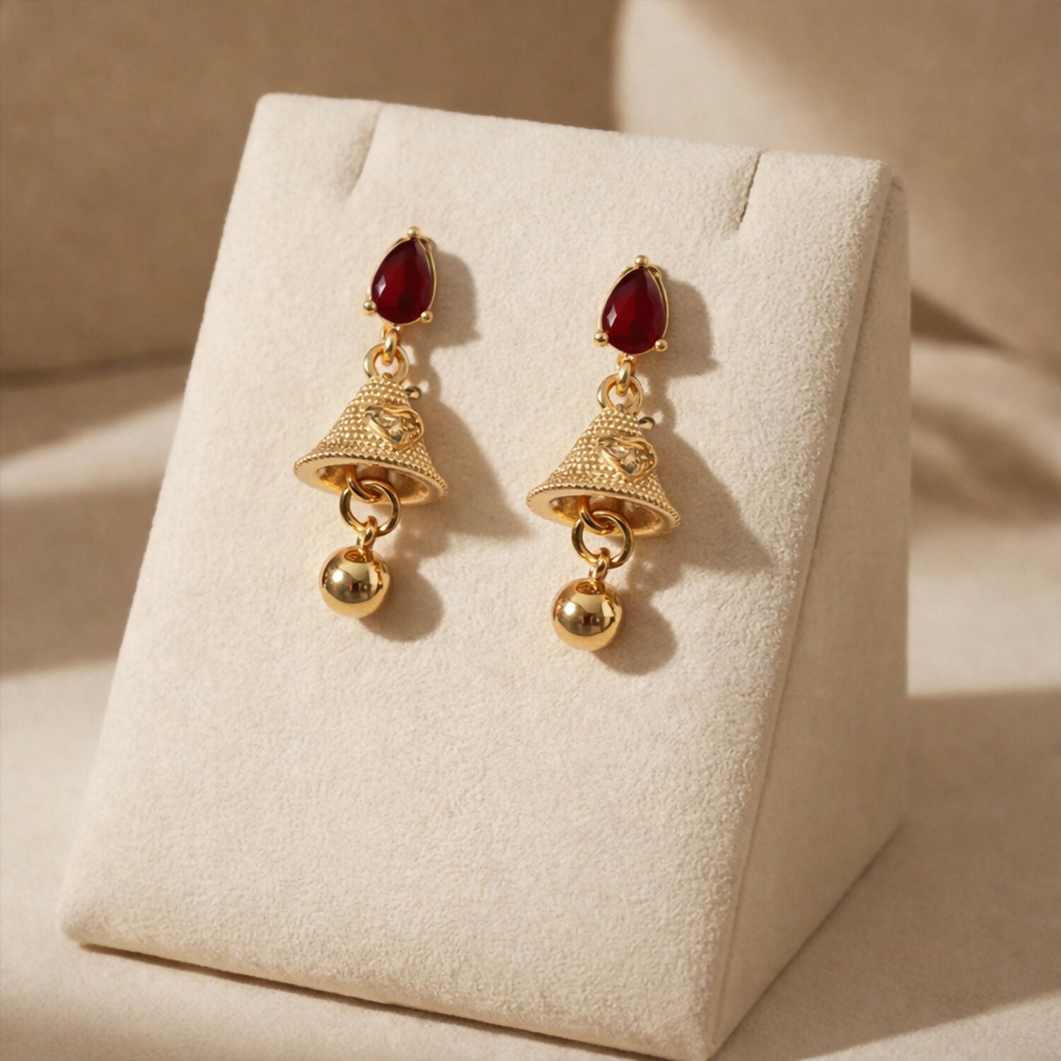 Ruby teardrop stud jhumka earrings with textured gold bell drop front view