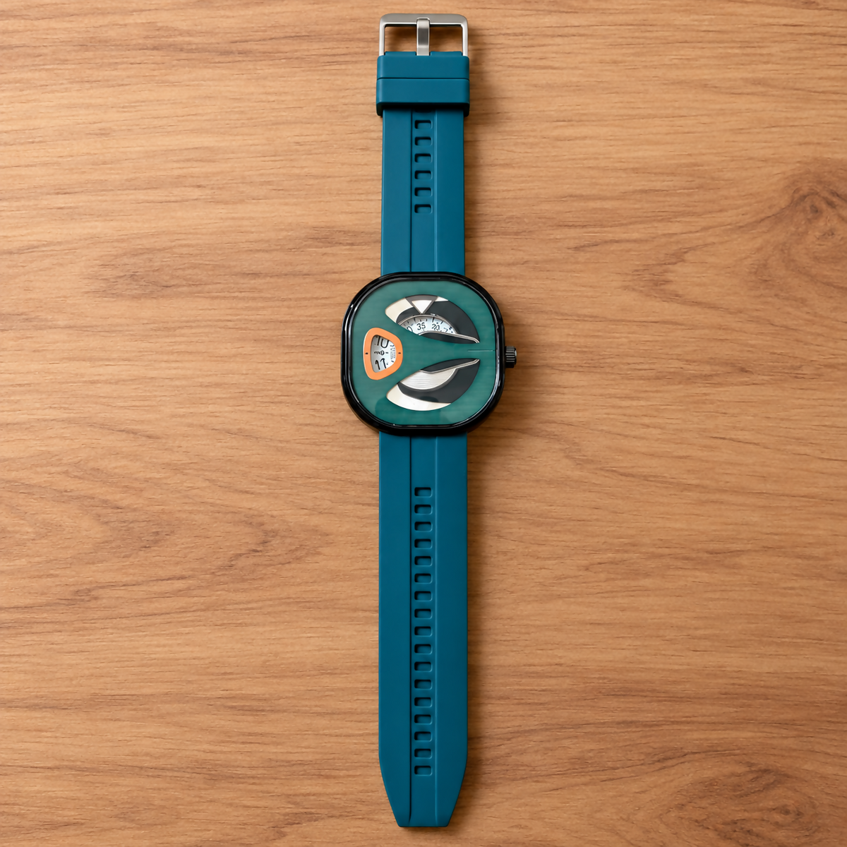 Top-down view of a green watch with a teal silicone strap and silver buckle, centered on a light wooden surface.