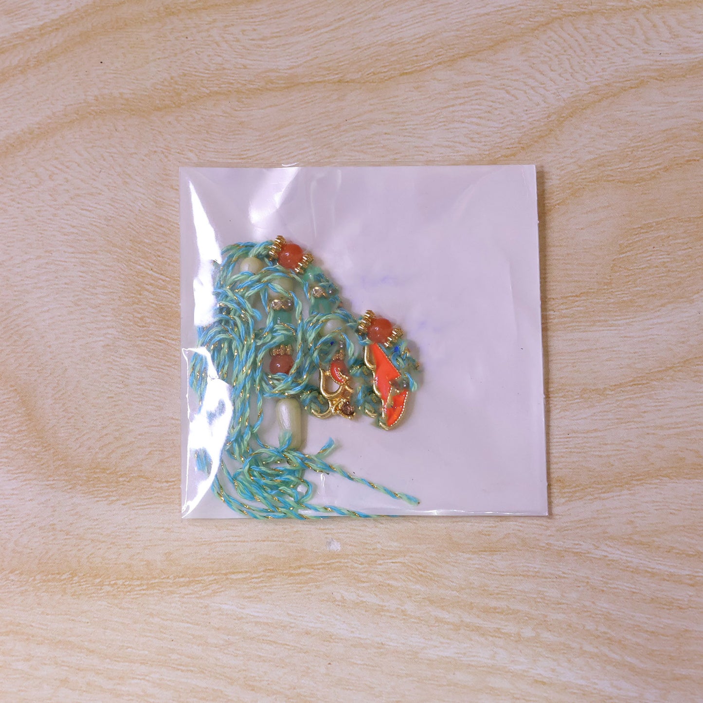 Traditional Rakhi with Om Symbol Charm and leaf detail in thread style for Gift Use