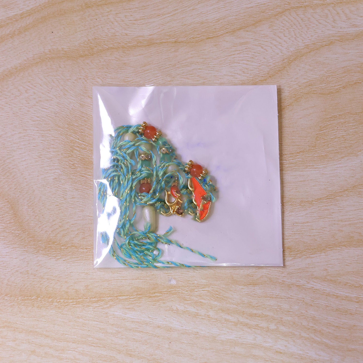 Traditional Rakhi with Om Symbol Charm and leaf detail in thread style for Gift Use
