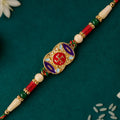 Festive Rakhi featuring Swastik Medallion and gold trims in display look for Gift Use