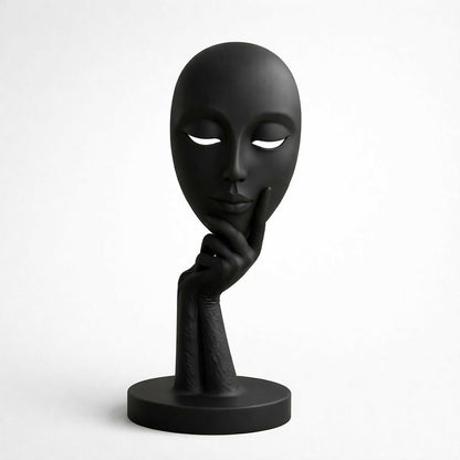 Abstract face statue placed on office desk for décor