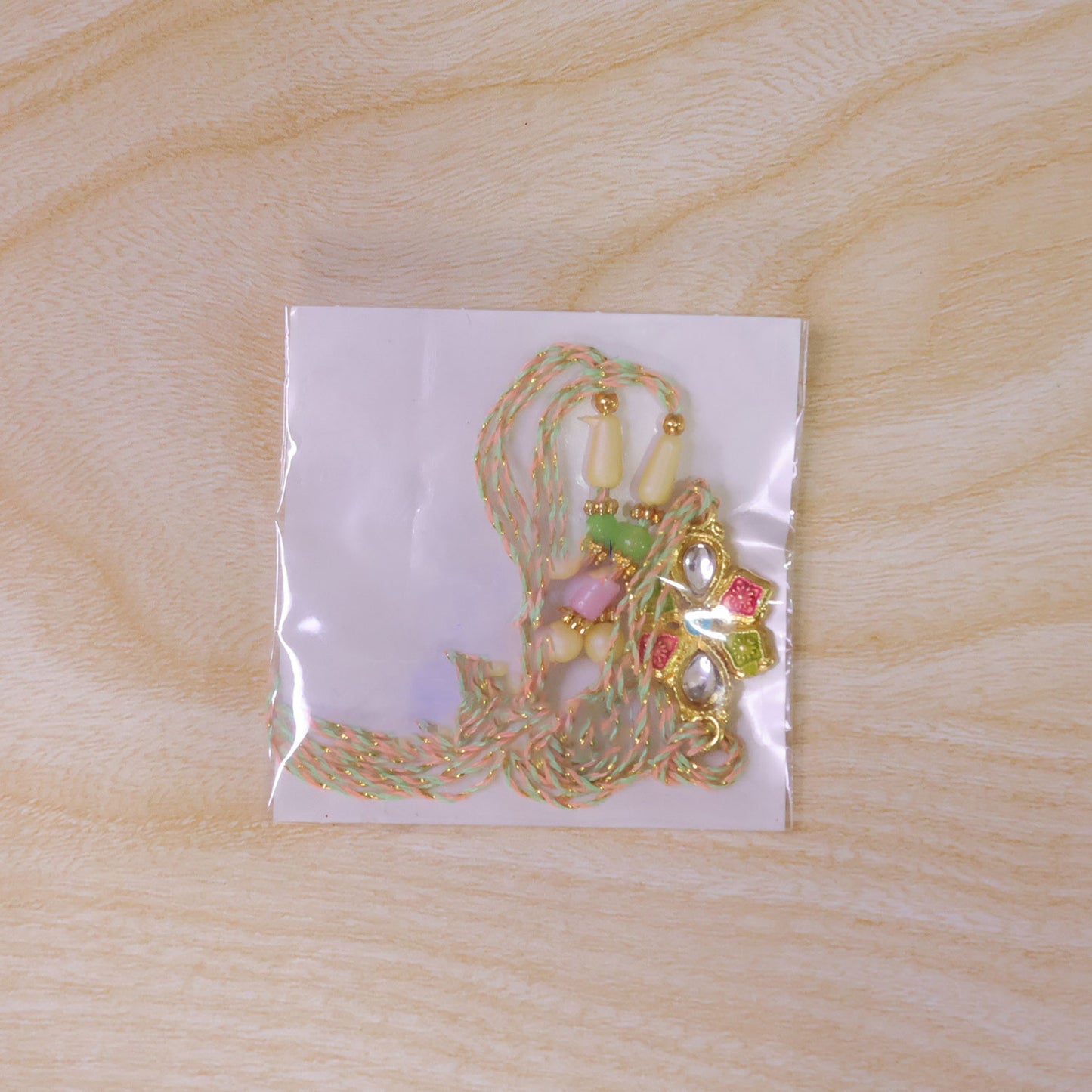 Floral Cross Kundan Pendant Rakhi with Multicolor Beads
