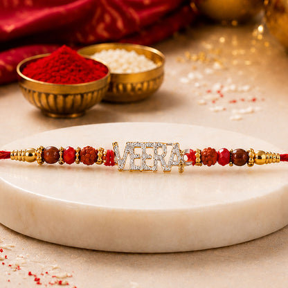 Veera Name Golden Designer Rakhi with Red Stones, Pearl Accents and Festive Beads