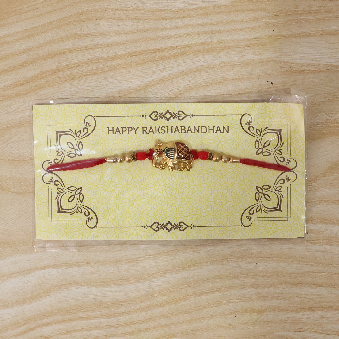 Gold Elephant Rakhi with Red Beads and Pearl Side Detailing