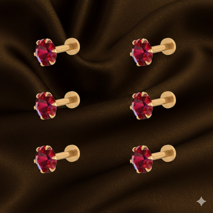Close-up of red ruby flat back nosepin stud in an elegant gold-plated setting