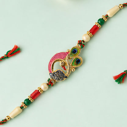 Peacock Rakhi Set with Red Thread, Gold Beads and Meenakari Accent Design