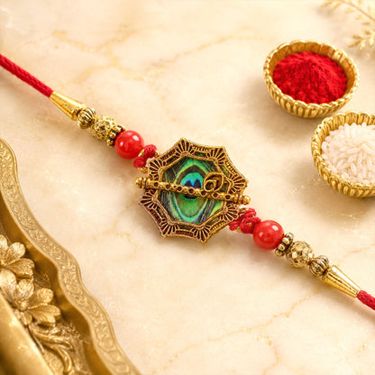 Shop Peacock Feather Rakhi Golden Frame Red Beads (5pcs)