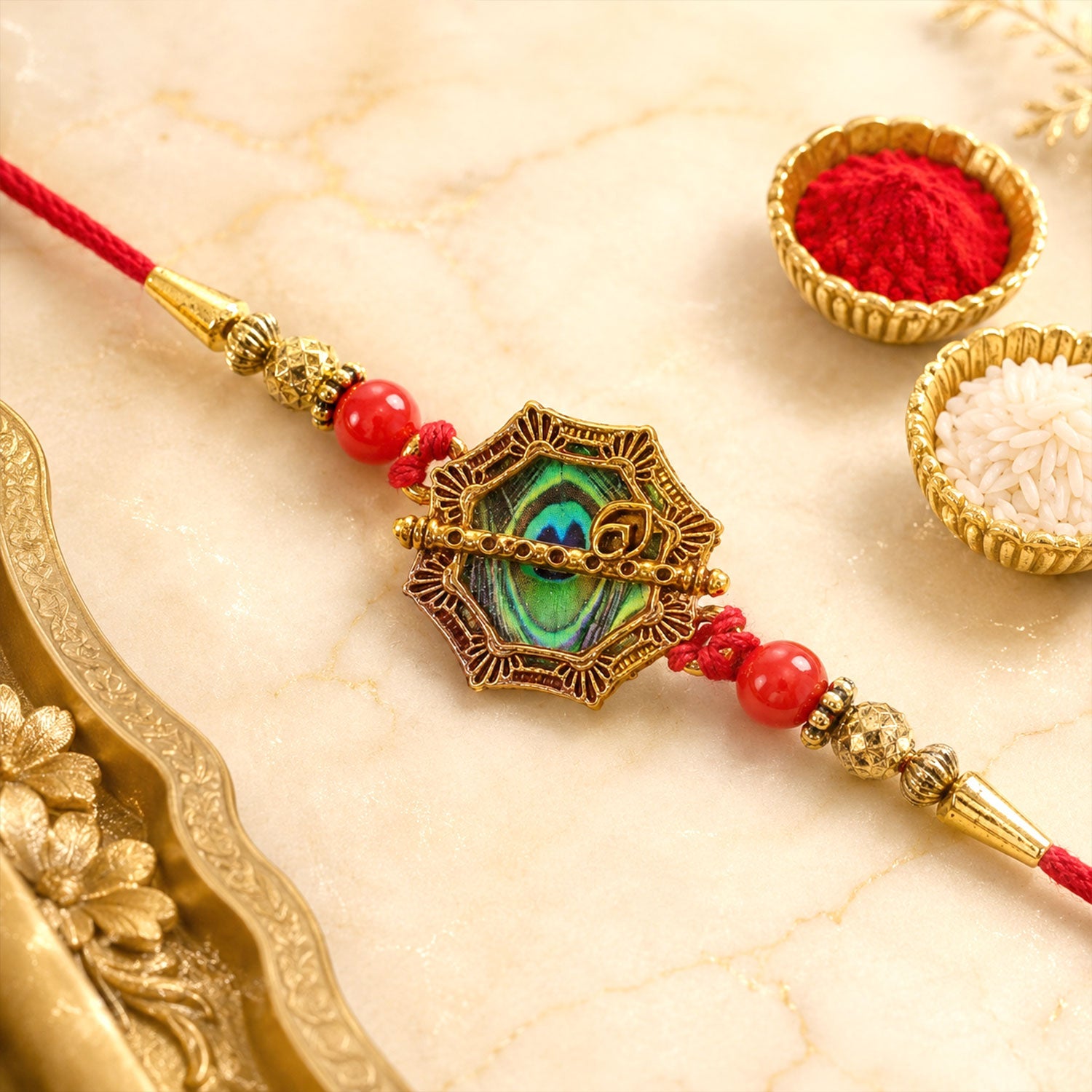 Shop Peacock Feather Rakhi Golden Frame Red Beads (10pcs)