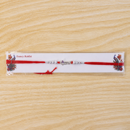 Silver Morpich Krishna Bead Rakhi with Tiny Purple Stone and Red Thread